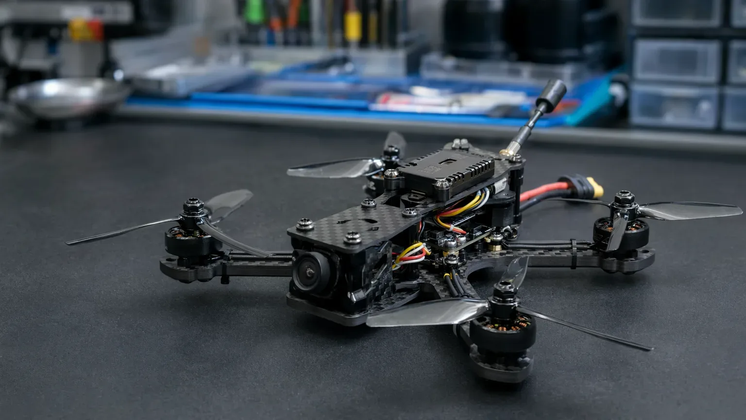 Build FPV compacto com módulo de vídeo instalado em frame de carbono, com damping visível