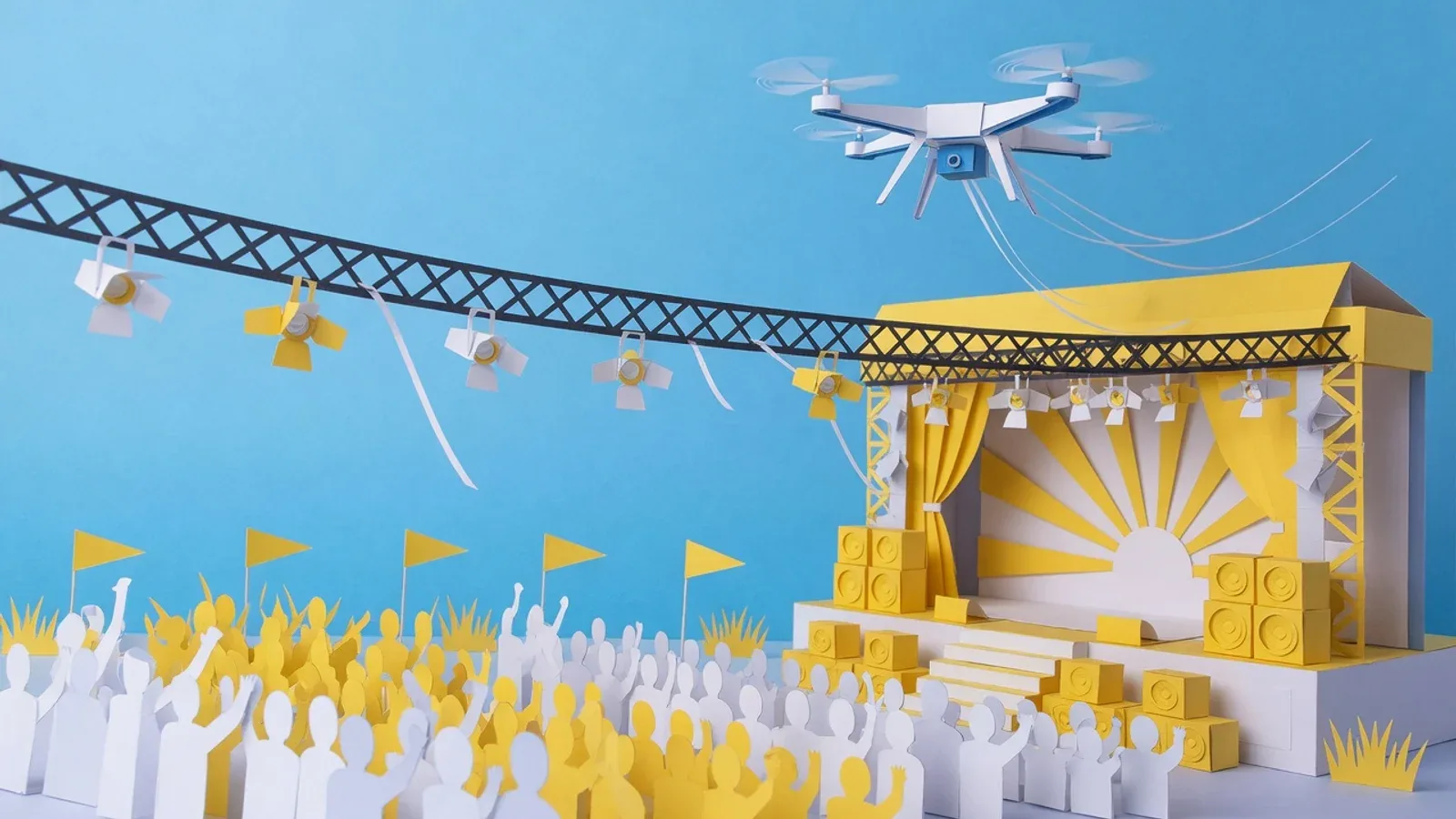 Palco de festival de música com estrutura de iluminação e drone sobrevoando a área técnica de segurança